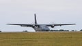 Parked airplane CASA CN-235 of French Air Force with spinning propellers