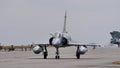 Frontal view of a combat jet plane on the runway with copy space