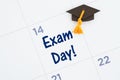 Exam day message with a calendar with a grad hat Royalty Free Stock Photo