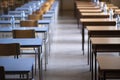 Exam examination room or hall set up ready for students to sit test. multiple desks tables and chairs. Education, school, student Royalty Free Stock Photo