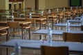 Exam examination room or hall set up ready for students to sit test. multiple desks tables and chairs. Education, school, student Royalty Free Stock Photo
