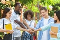 Exam Pass Celebration. Group Of College Students Stacking Hands Together Outdoors Royalty Free Stock Photo