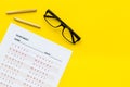 On the exam. Exam sheet, answer near glasses and pencil on yellow background top view copy space Royalty Free Stock Photo