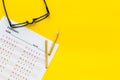 On the exam. Exam sheet, answer near glasses and pencil on yellow background top view copy space Royalty Free Stock Photo