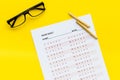 On the exam. Exam sheet, answer near glasses and pencil on yellow background top view copy space Royalty Free Stock Photo