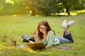 Exam Study. Serious young student girl reading book outdoors in park Royalty Free Stock Photo