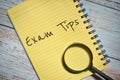 Exam Tips wording with magnifying glass over yellow paper