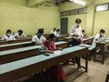 An examination hall with medical students and invigilator maintaining covid norms. Royalty Free Stock Photo