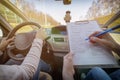 Examiner filling in driver`s license road test form