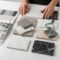 Examining marble samples with magnifying glass Royalty Free Stock Photo