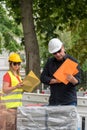 Examining plans on construction site