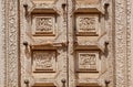 Example of Indian wood carvings with ancient life of ancient people, on door of the Palace of Mysore, India.