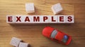 EXAMPLE word made with wooden blocks and red toy car. Logistic transportation concept Royalty Free Stock Photo