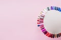 Examples of nails tips on pastel pink background top view. Manicure fashion modern bright colors. Trendy minimal pop art