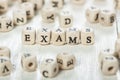 Exams word written on wood block. Royalty Free Stock Photo