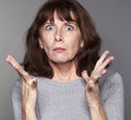 Exasperated mature woman with tense eyes wide open Royalty Free Stock Photo