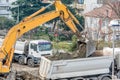 Exavator loading earth in the truck on construction site Royalty Free Stock Photo