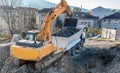 Exavator loading earth in the truck on construction site Royalty Free Stock Photo