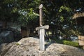 Excalibur, King Arthur\'s sword in stone. Edged weapons from the legend Pro king Arthur Royalty Free Stock Photo
