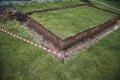Excavated ground under the foundation of the house, fenced with a red warning tape