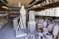 Excavated statue, anchor and urns from Pompeii city