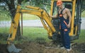 Excavation concept. Man operated excavator for ground excavation. Digger operator work on excavation site. Excavation