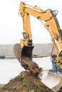 Excavation industrial work. A bulldozer pours out a bucket of land on a construction site close-up Royalty Free Stock Photo