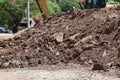 Excavation of large piles of soil in the outdoor industrial construction site.