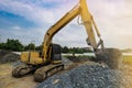 Excavation is working on the construction site at the sunset time in the summer season Royalty Free Stock Photo