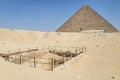 Excavations in front of the great Pyramid of Cheops in Giza valley. Cairo Egypt. Pyramids of Khafra against the blue sky Royalty Free Stock Photo