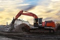 Excavator with attachment for demolishing and recycling concrete material. Crushers tool and Demolition Pulverizer. Concrete Saw, Royalty Free Stock Photo