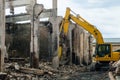 Excavator with attachment steel grappling hydraulic pliers in collapsed industrial building