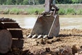 Excavator or backhoe bucket on the soil floor.