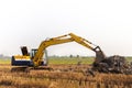 excavator backhoe working in the digging a soil to adjust the postharvest areas in the rice fields. agriculture machinery for