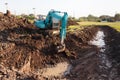 excavator backhoe working in the digging a soil to adjust the postharvest areas in the rice fields. agriculture machinery for