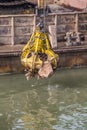 Excavator on barge with hydraulic rotator stone grab