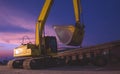 Excavator and barge waiting to be unloaded at harbor against twilight sky after sundown in the evening