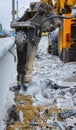 Excavator breaking and drilling the concrete road for repairing