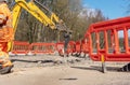Excavator breaking and drilling the concrete and road surface. Large hydraulic hammer mounted on the arm of an excavator closeup