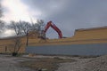 Excavator demolishing a building wall Royalty Free Stock Photo