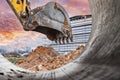 Excavator bucket close-up against the blue sky digs the ground. Earthworks with heavy equipment at the construction site Royalty Free Stock Photo