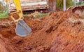 Excavator bucket digging soil for loading to truck. Earthwork. Dirt metal bucket of backhoe working at a construction site. Royalty Free Stock Photo