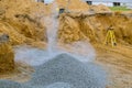 Excavator bucket moving gravel stones for foundation building Royalty Free Stock Photo