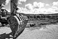 Excavator bucket near the vineyard