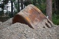 Excavator bucket resting on soil Royalty Free Stock Photo