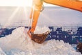 Excavator bucket with snow. Cleaning and removal of snow in winter Royalty Free Stock Photo