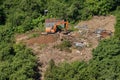 Excavator and builders destroy illegal buildings in the park