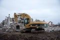 Excavator CATERPILLAR 325CL at demolition of tall building. Hydraulic machine for demolish. Backhoe
