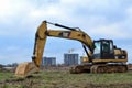 Excavator CATERPIlLAR 320DL working at construction site. Construction machinery for excavation,