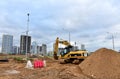 Excavator CATERPILLAR working at construction site. Construction machinery for excavation, loading, lifting and hauling of cargo